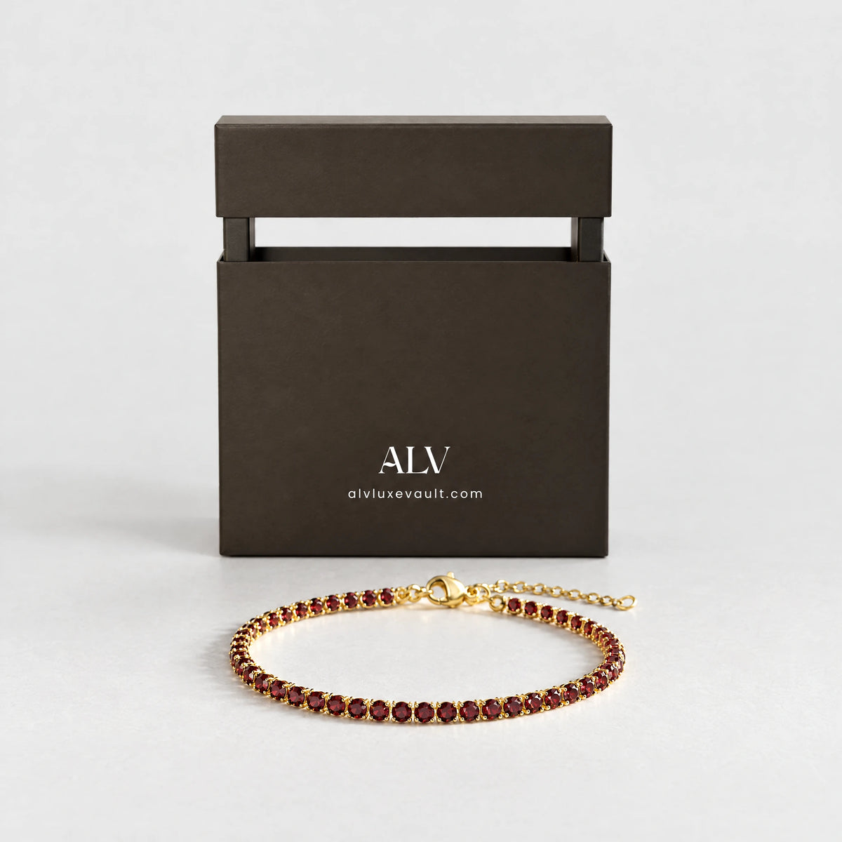Gold MAYA Birthstone Tennis Bracelet with garnet-red crystals presented with the ALV gift box
