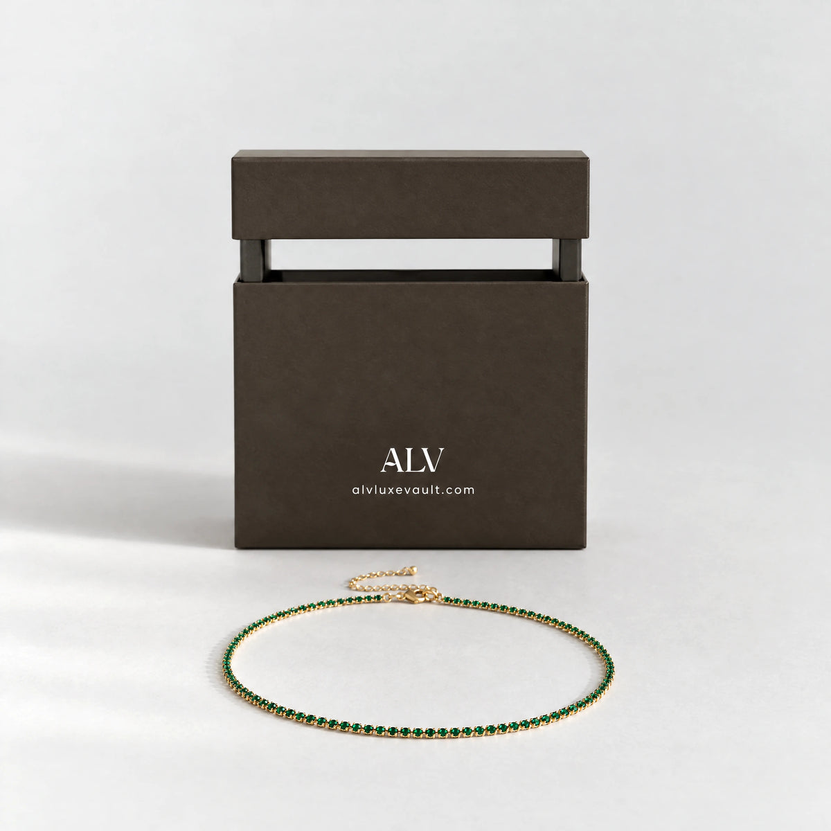 Gold Tessa Birthstone Tennis Necklace beside the ALV gift box
