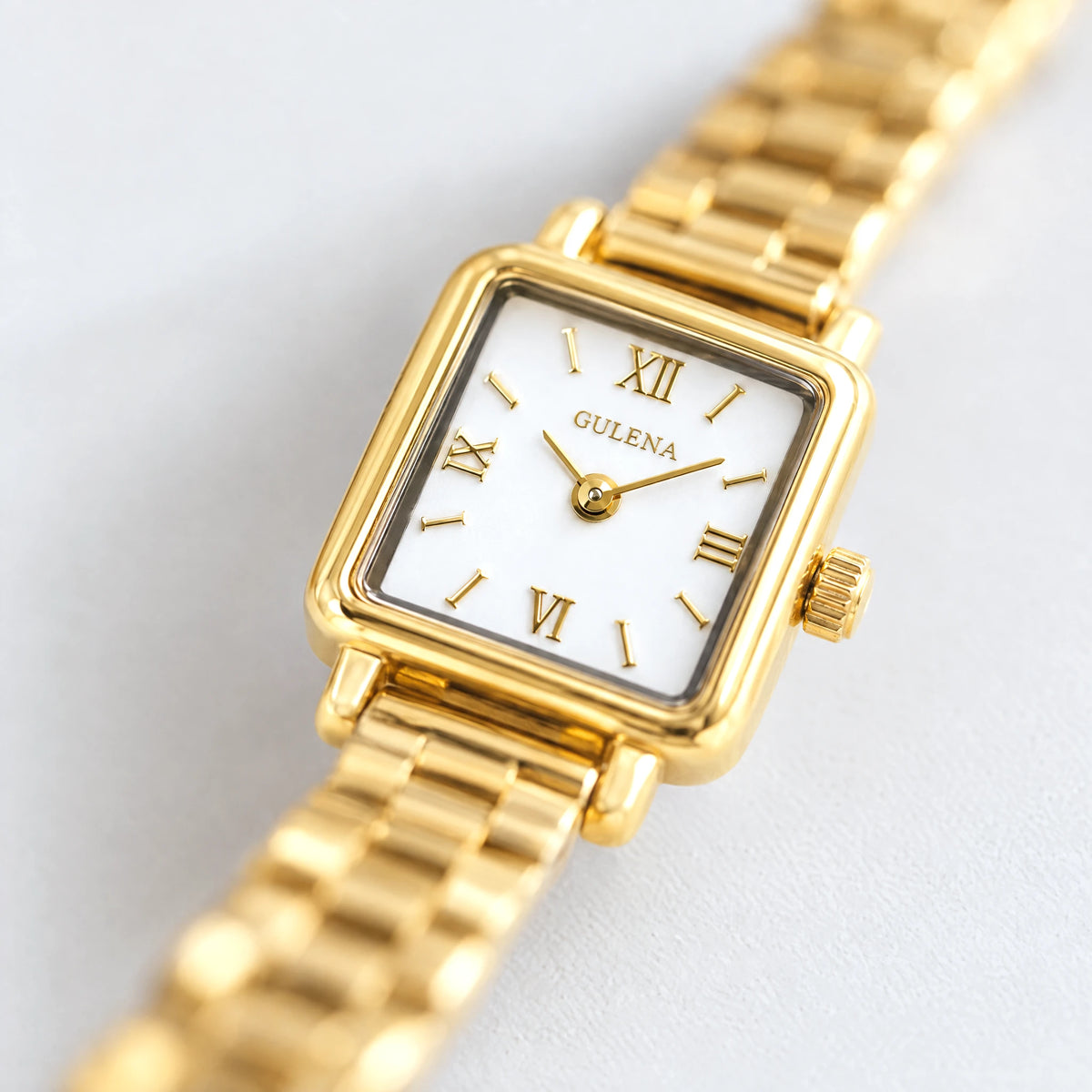 Close-up of the square case and Roman numeral dial of the gold CLARA Square Bracelet Watch