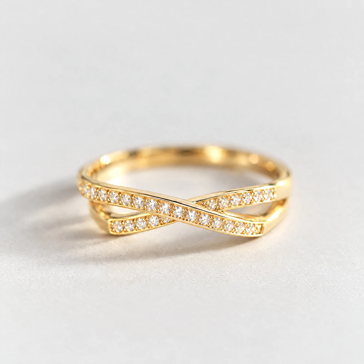 Close-up of the crossing bands and pavé crystals on the gold Ivy Crossover Crystal Ring