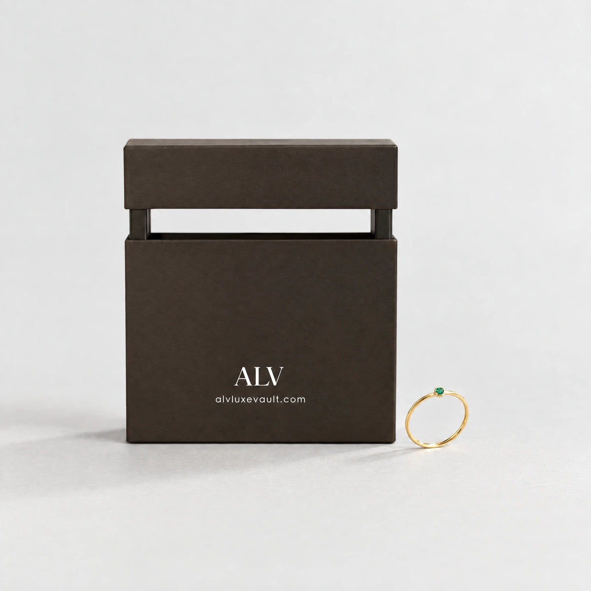 Gold Lena Birthstone Ring beside the ALV gift box
