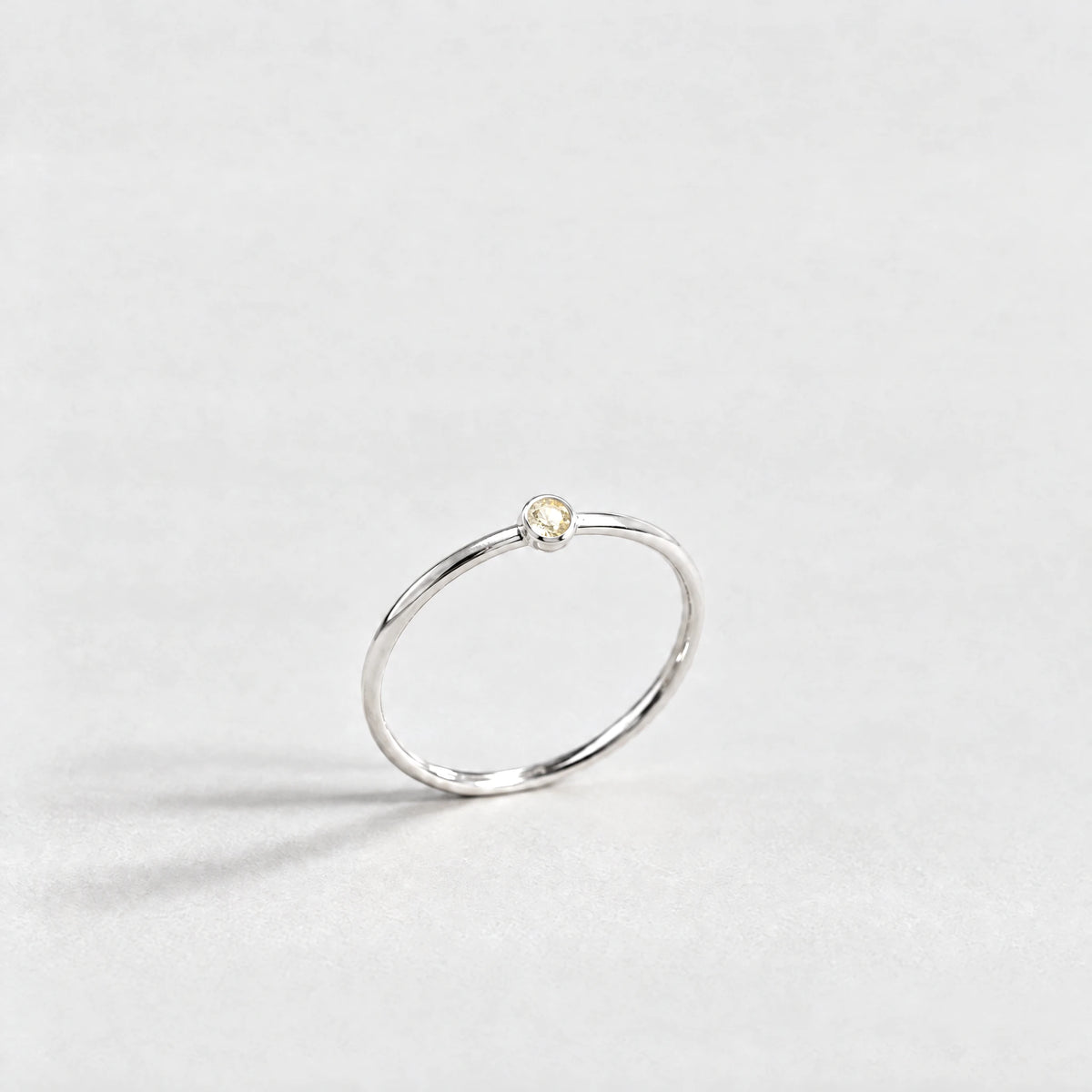 Silver Lena Birthstone Ring with citrine champagne November birthstone-color crystal on a light grey background