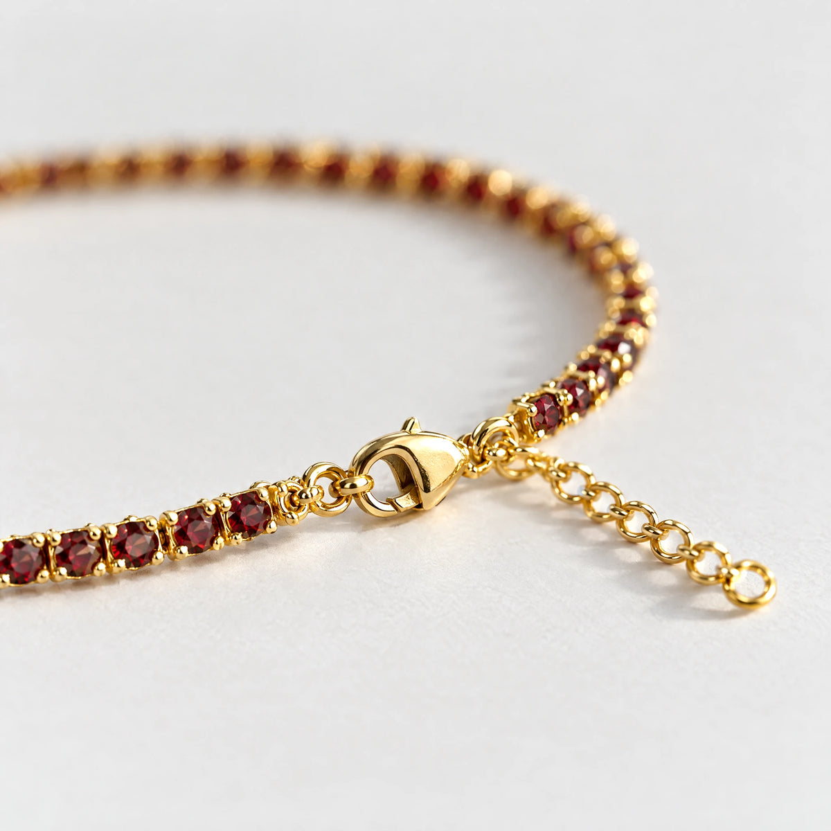 Lobster clasp and extender chain of the gold MAYA Birthstone Tennis Bracelet with garnet-red crystals