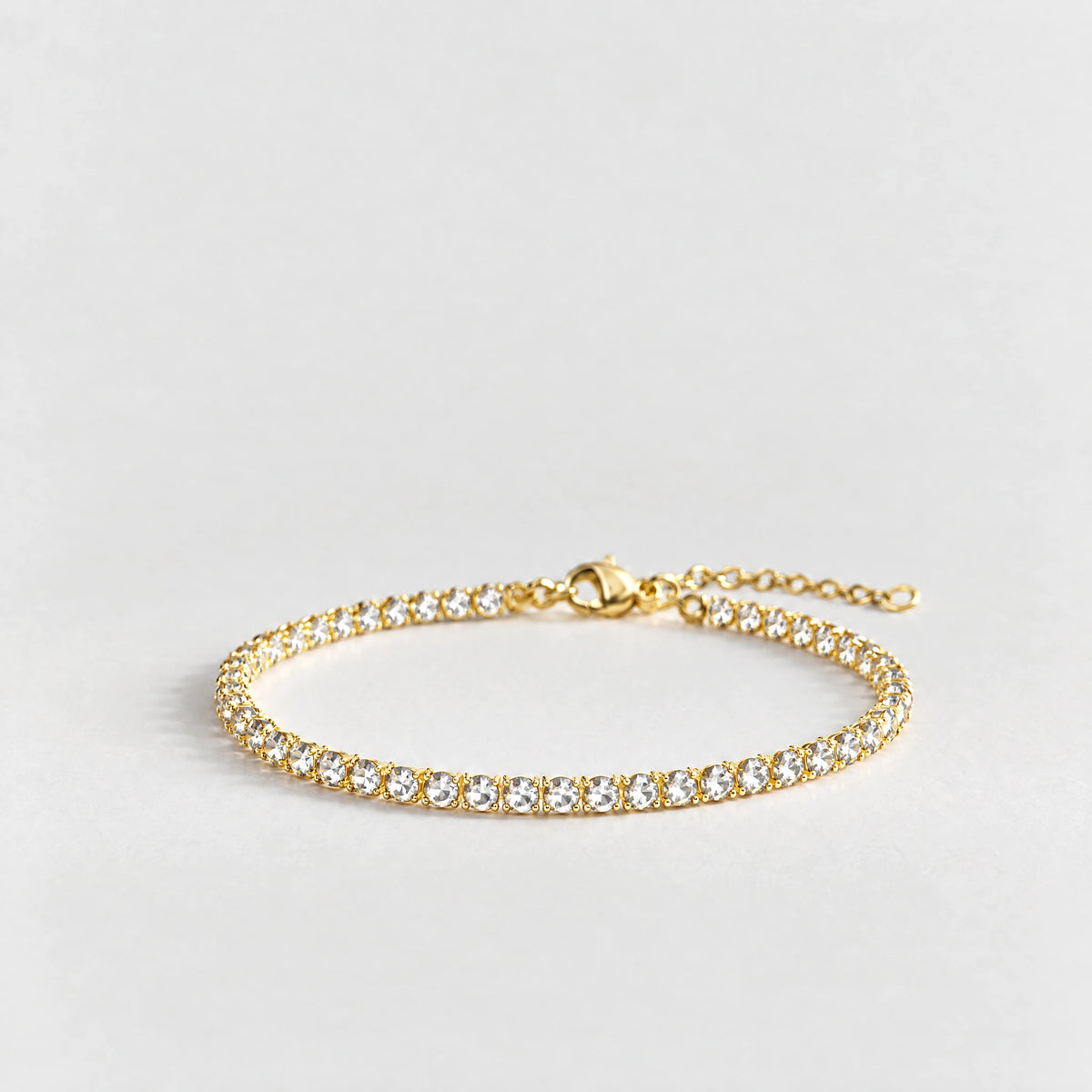 MAYA Birthstone Tennis Bracelet in gold plating with clear crystals for April