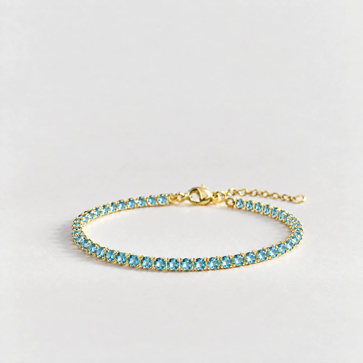 MAYA Birthstone Tennis Bracelet in gold plating with aquamarine-blue crystals for December