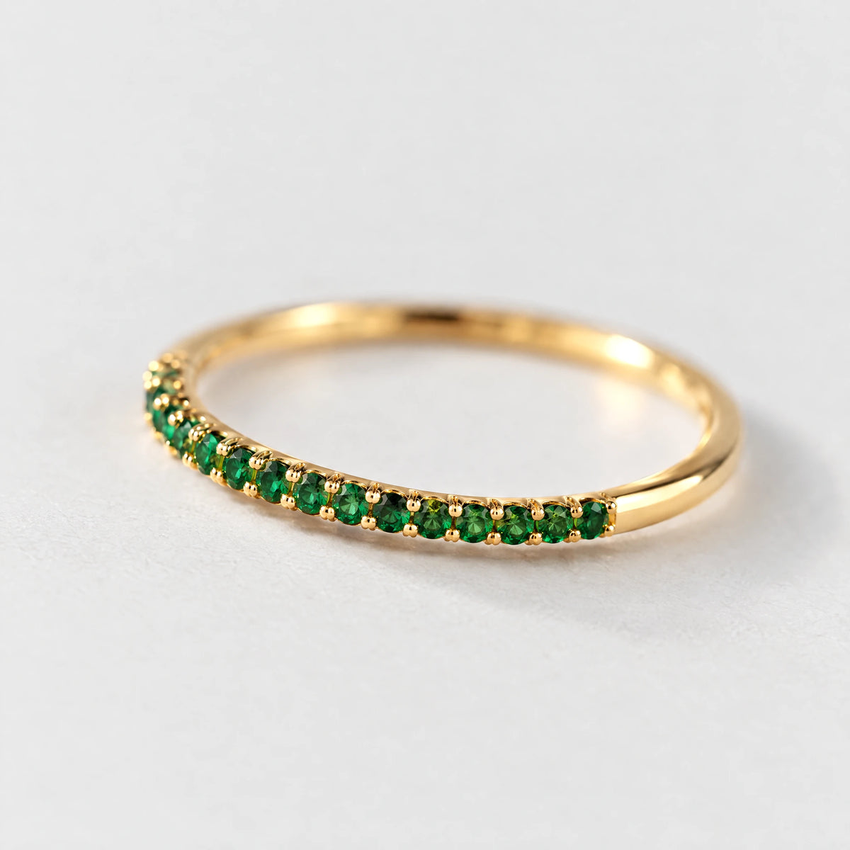Close-up of the pave-set green stones on the gold Nora Birthstone Stacking Ring