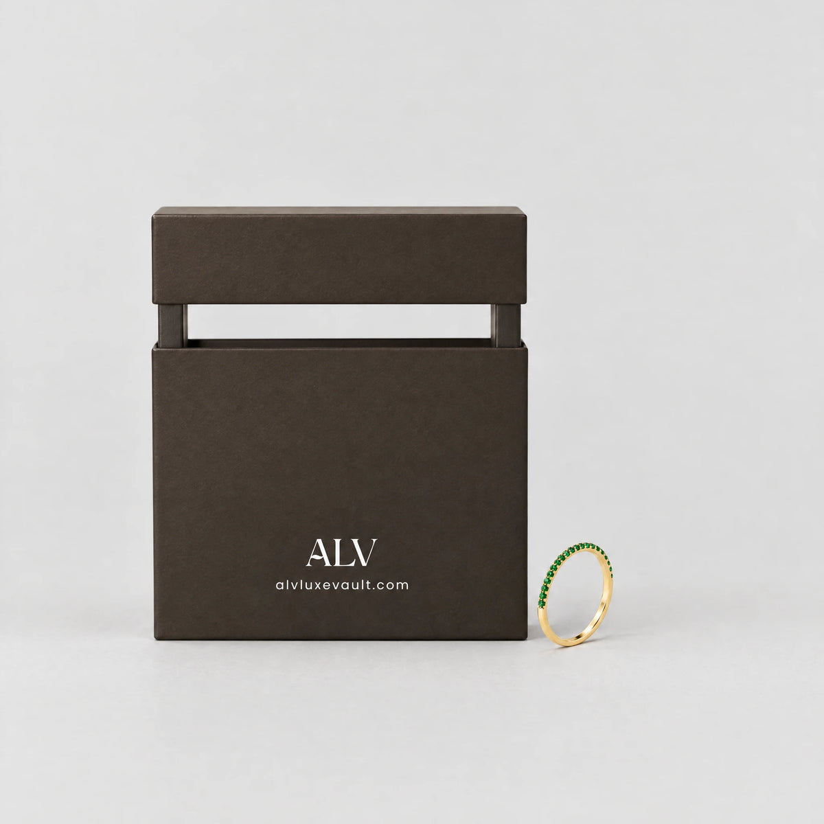 Gold Nora Birthstone Stacking Ring beside the ALV gift box