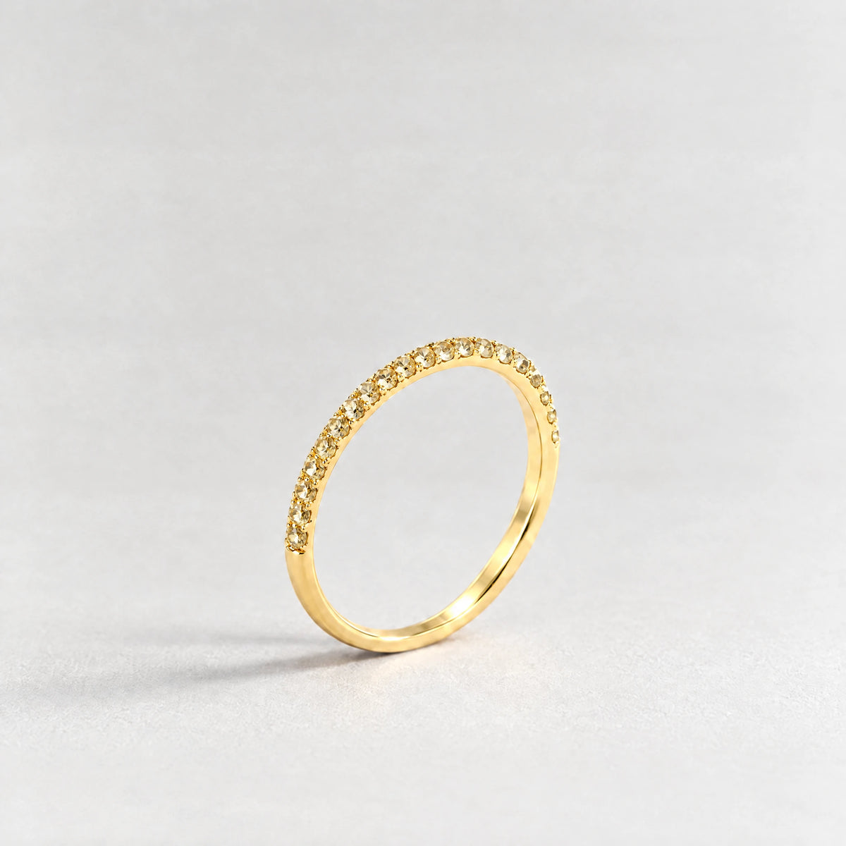 Gold Nora Birthstone Stacking Ring with citrine champagne November birthstone-color crystals on a light grey background