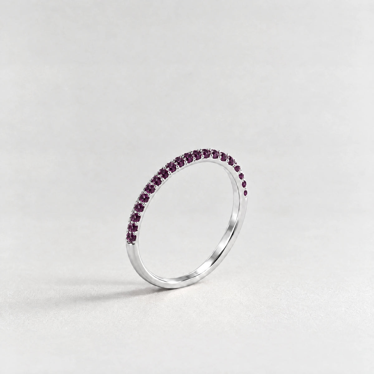 Silver Nora Birthstone Stacking Ring with alexandrite plum June birthstone-color crystals on a light grey background