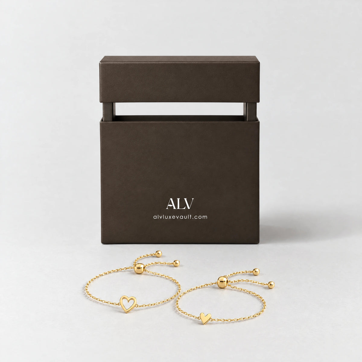 Gold Rosie Two Hearts Bracelet Set beside the ALV gift box