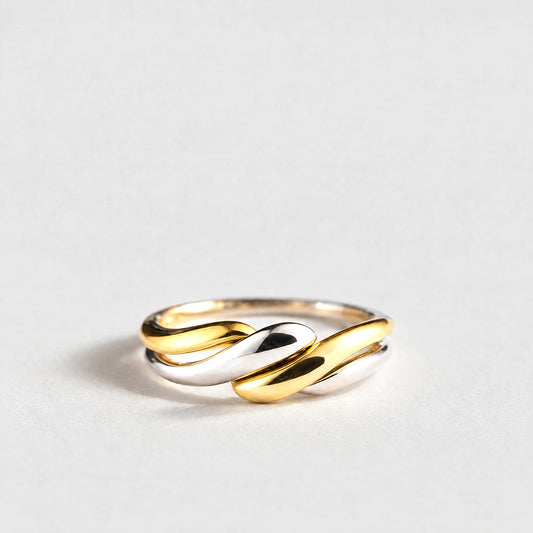 Siena Two-Tone Twist Ring in gold and silver tones on a light grey background