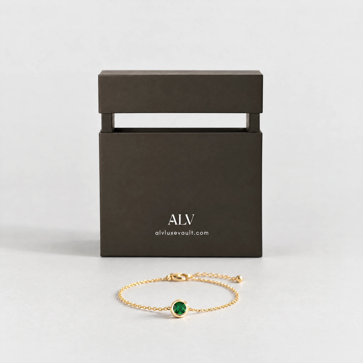 Gold Zara Birthstone Charm Bracelet beside the ALV gift box